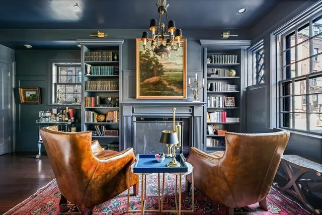 a living room with fireplace furniture and a book shelf