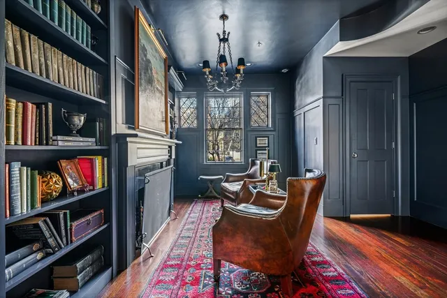 a living room with fireplace furniture and a book shelf