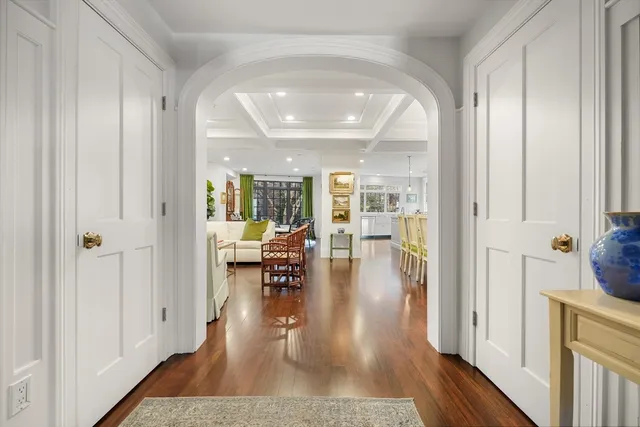 wooden floor with a dining table and chairs in a room
