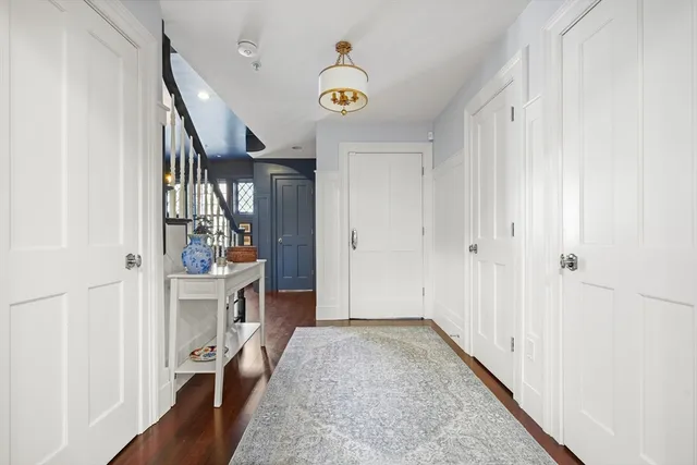 a view of an entryway with wooden floor