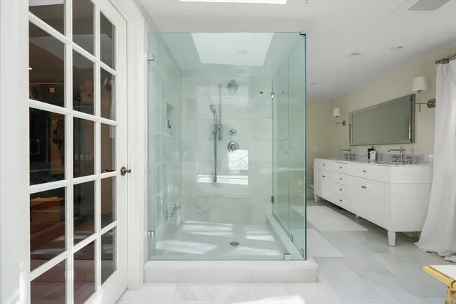 a bathroom with a shower and a sink