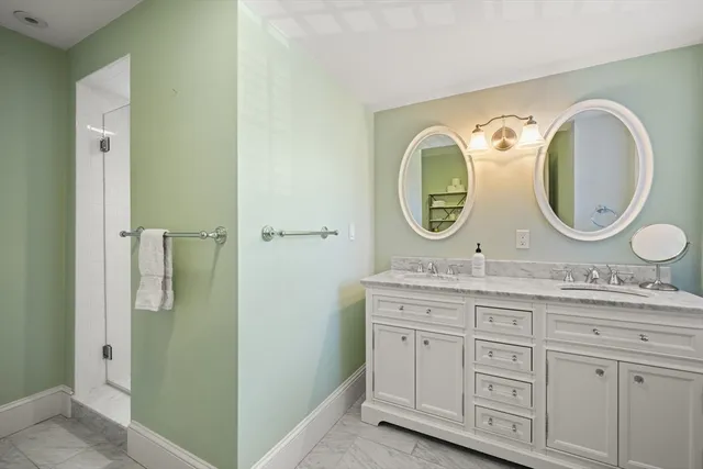 a bathroom with a granite countertop toilet sink and mirror