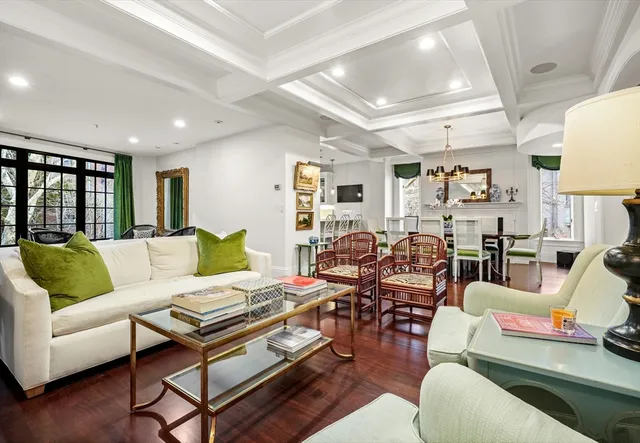 a living room with furniture kitchen view and a window