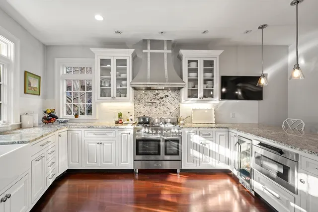 a kitchen with stainless steel appliances granite countertop a stove and cabinets