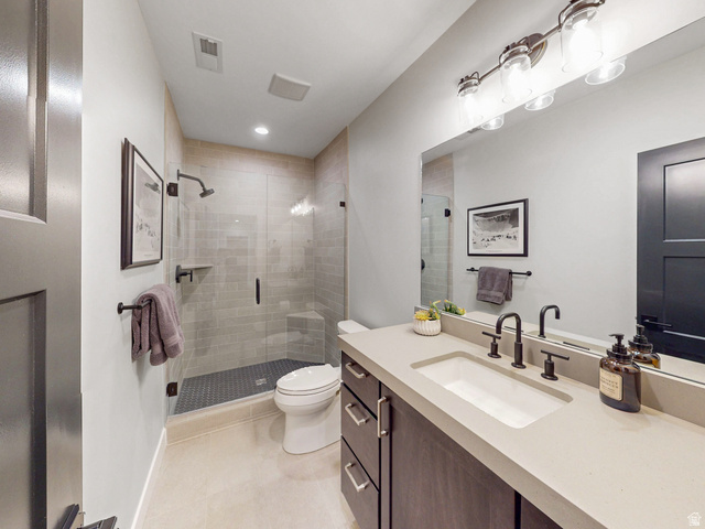 355 East Overlook Loop Hideout, UT 84036 - Photo 36 of 40 Second lower level bathroom is a contemporary featuring a dark wood-finish vanity with an integrated sink and light-toned countertop