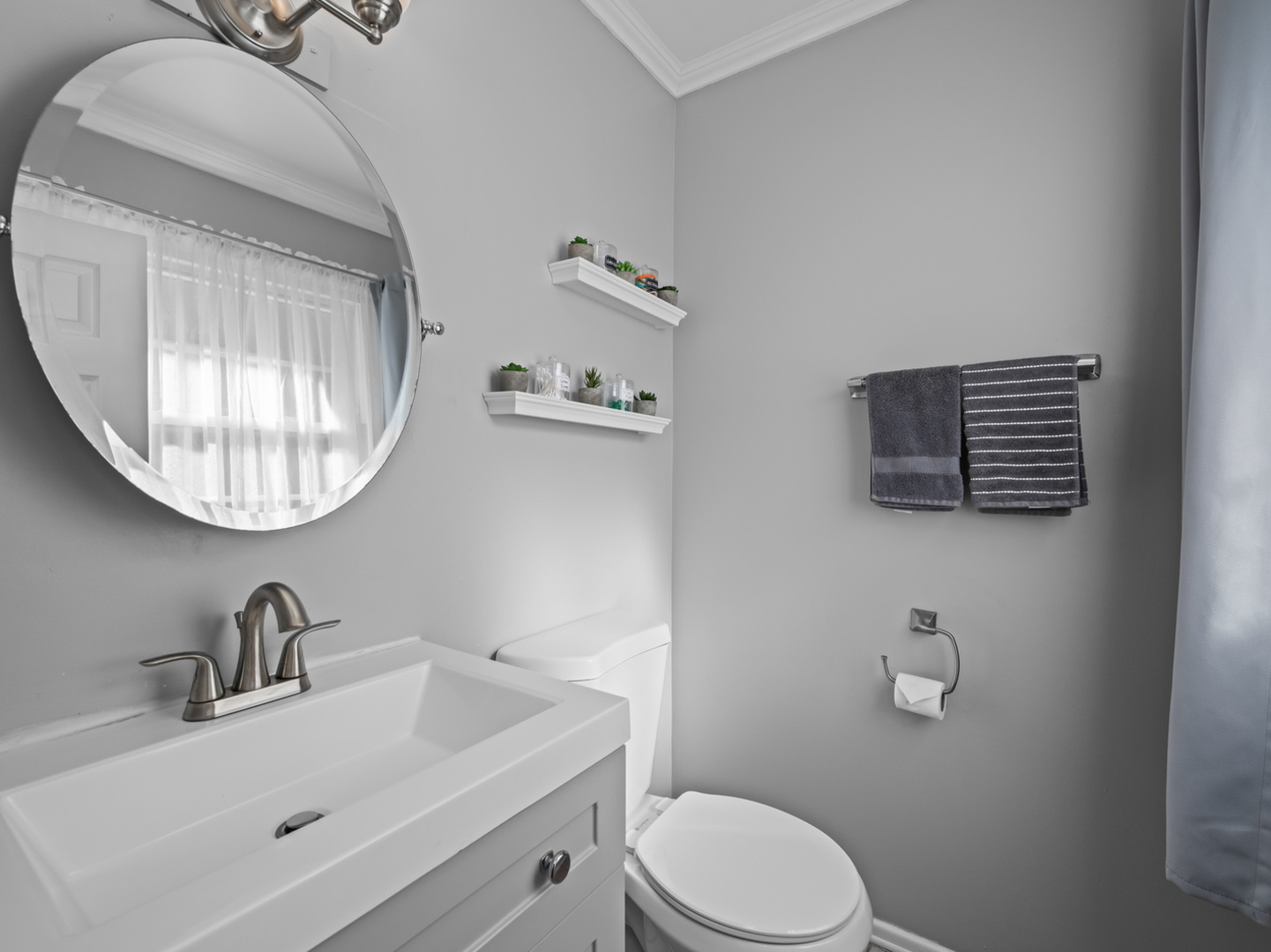 1905 Pierce Road Hoffman Estates, IL 60169 - Photo 15 of 27 a bathroom with a toilet a sink and mirror