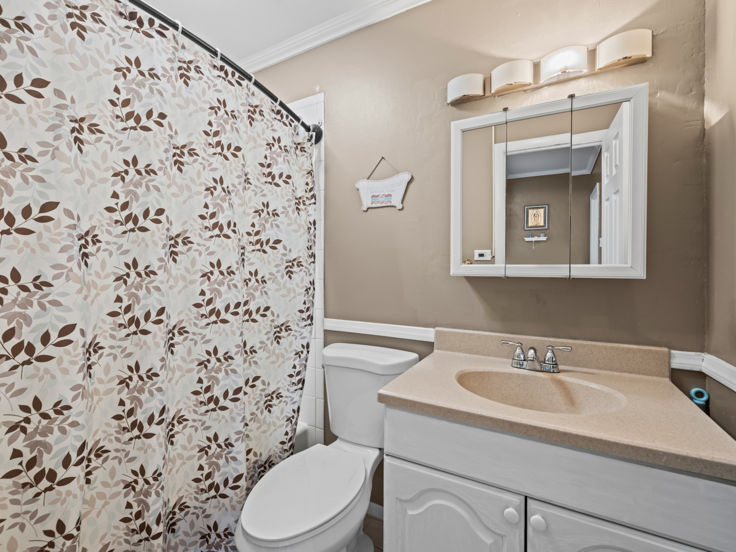 1905 Pierce Road Hoffman Estates, IL 60169 - Photo 18 of 27 a bathroom with a sink a toilet and shower curtain