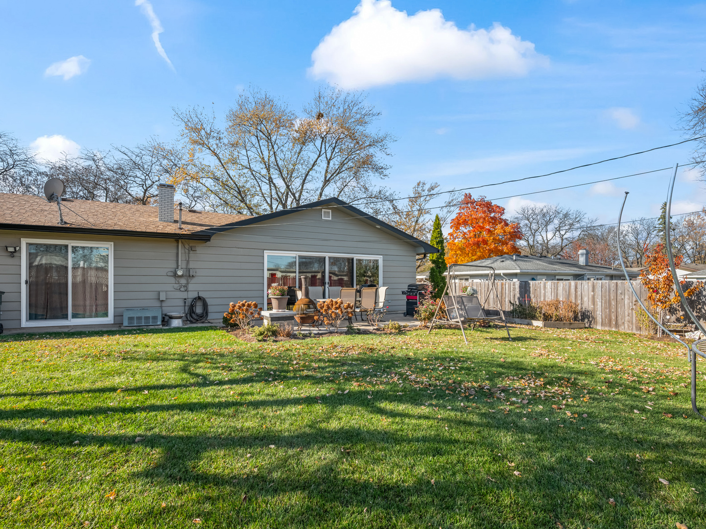 1905 Pierce Road Hoffman Estates, IL 60169 - Photo 24 of 27 a front view of a house with a yard table and chairs