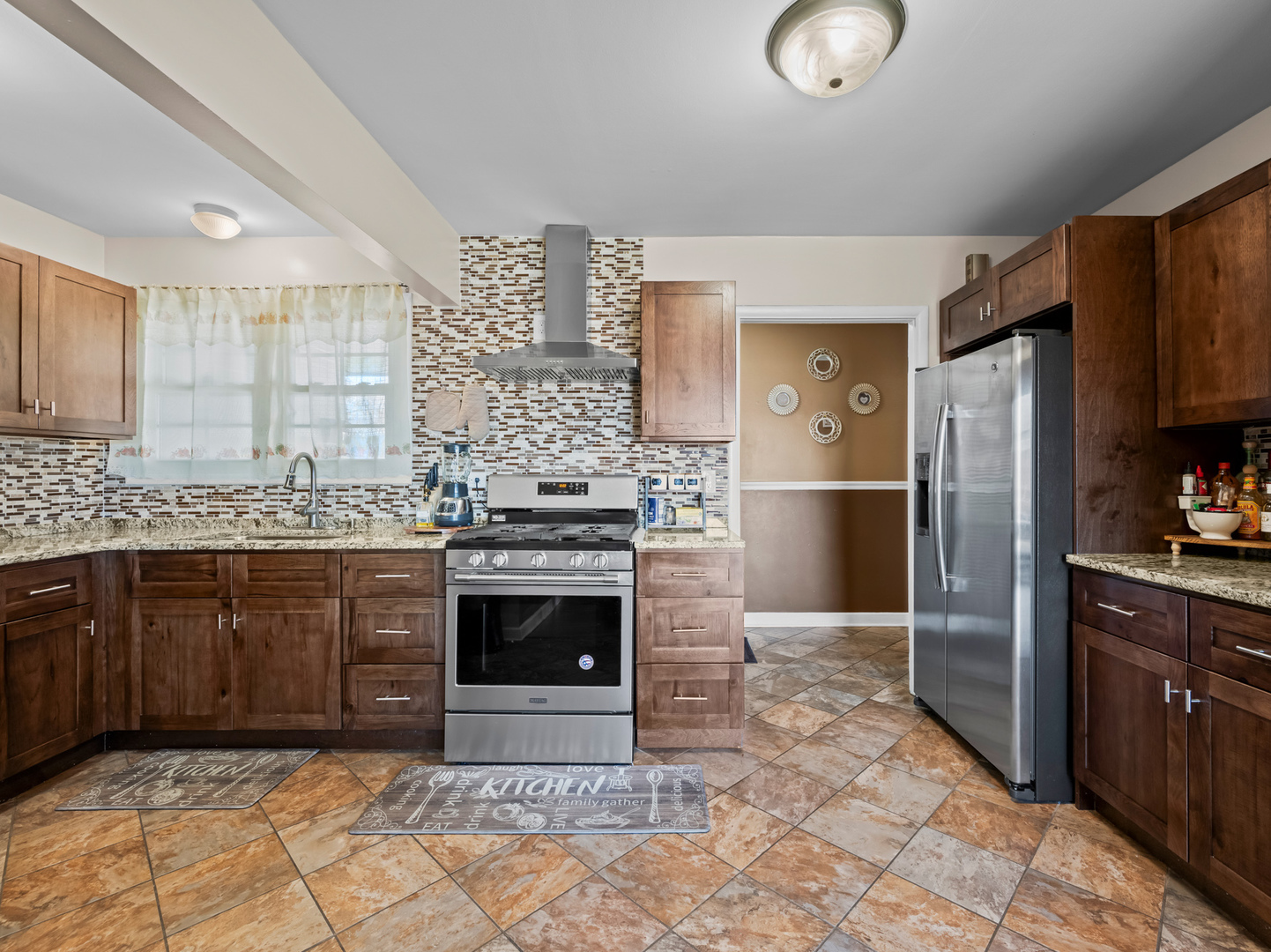 1905 Pierce Road Hoffman Estates, IL 60169 - Photo 6 of 27 a kitchen with stainless steel appliances granite countertop a stove a sink and a refrigerator