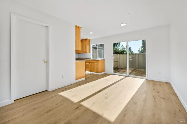 a room with a bed and a wooden floor