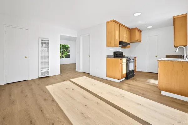 a bedroom with a bed and a view of kitchen