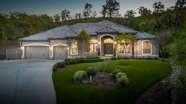 a front view of a house with a garden