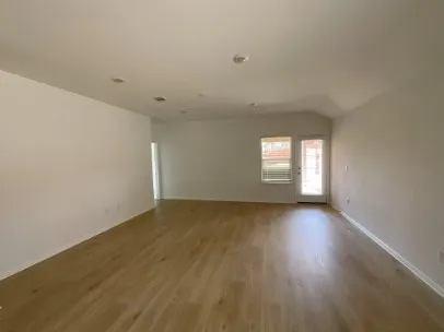 a kitchen with granite countertop a refrigerator stove top oven and sink