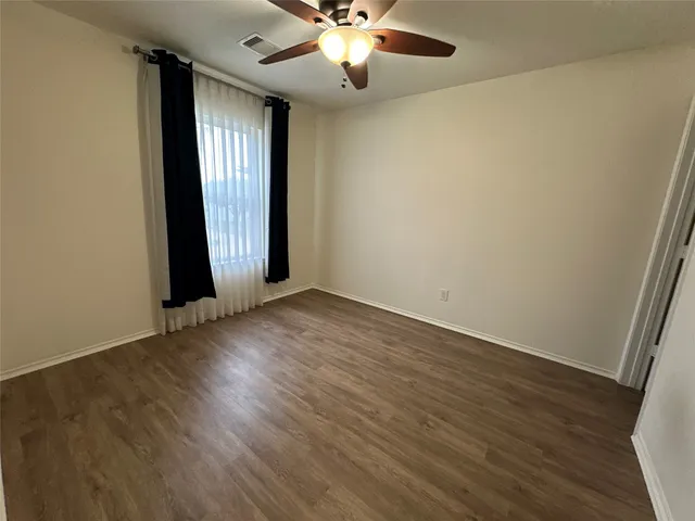 a bathroom with a wooden floor