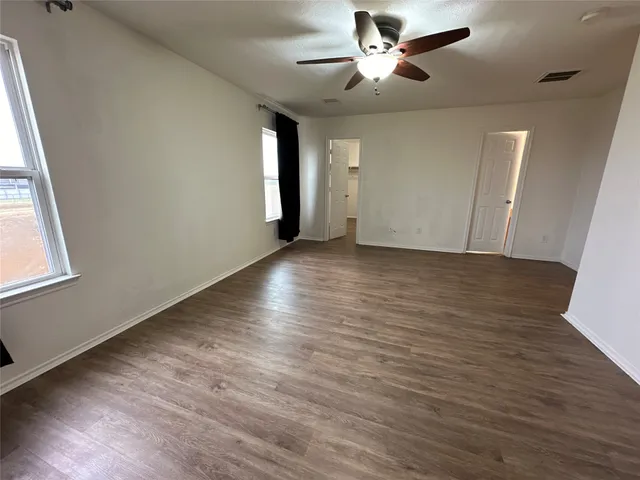 a view of a room with wooden floor