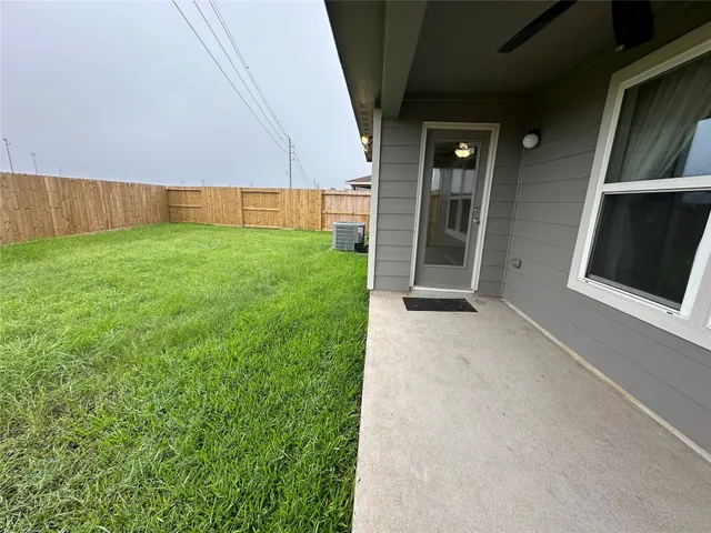a view of a backyard with wooden fence