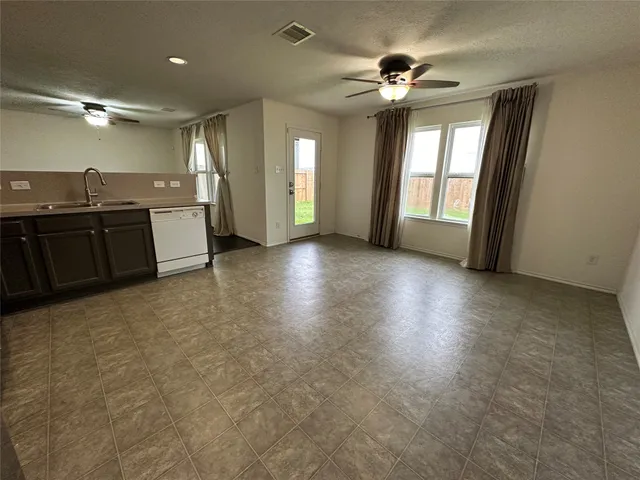 a view of a kitchen with a sink and a stove top oven