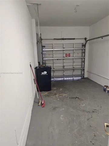 a view of backyard with a barbeque and a large tree