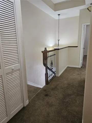 a view of a hallway with entryway door