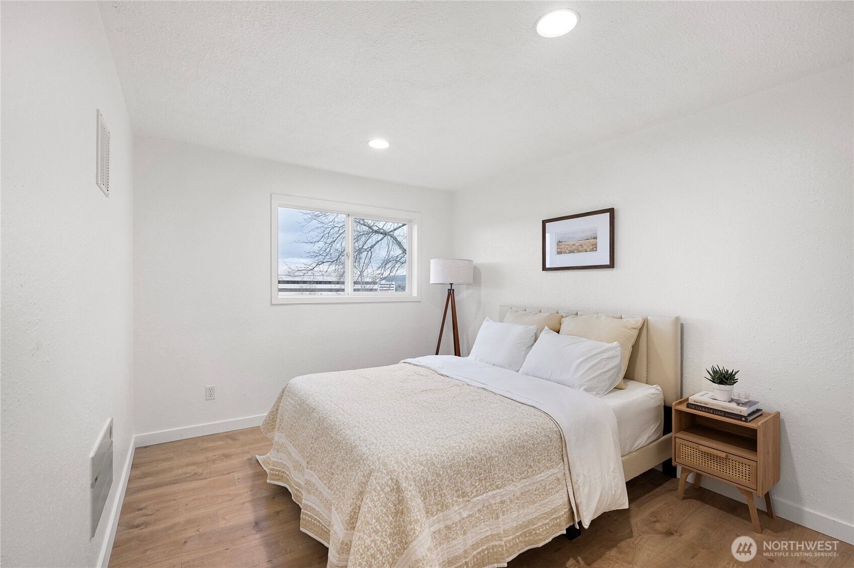 1406 Shattuck Avenue South Renton, WA 98055 - Photo 13 of 22 a bedroom with a bed and a painting on the wall