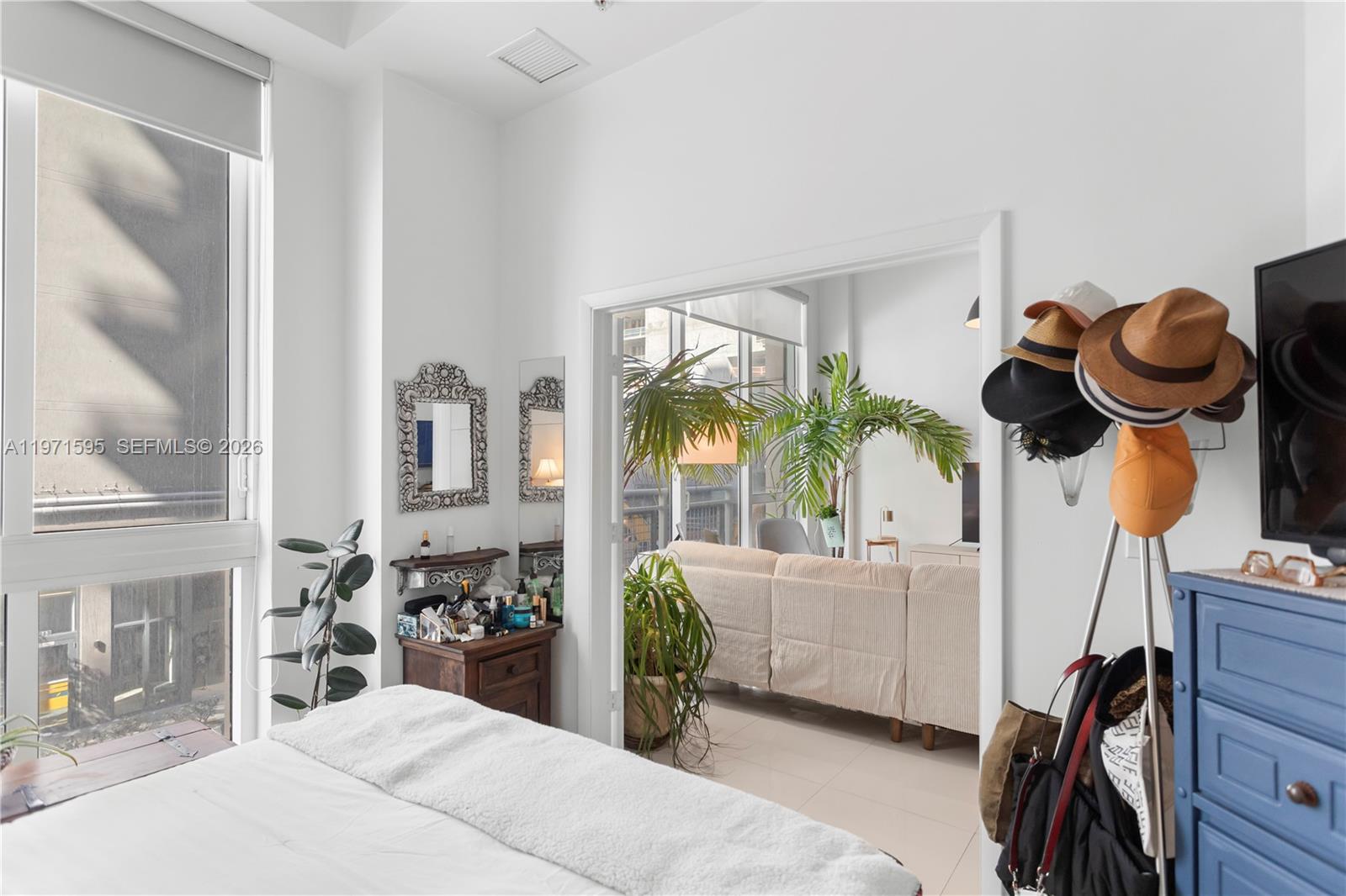 244 Biscayne Boulevard, Unit 252 Miami, FL 33132 - Photo 11 of 18 a bedroom with furniture and a large window