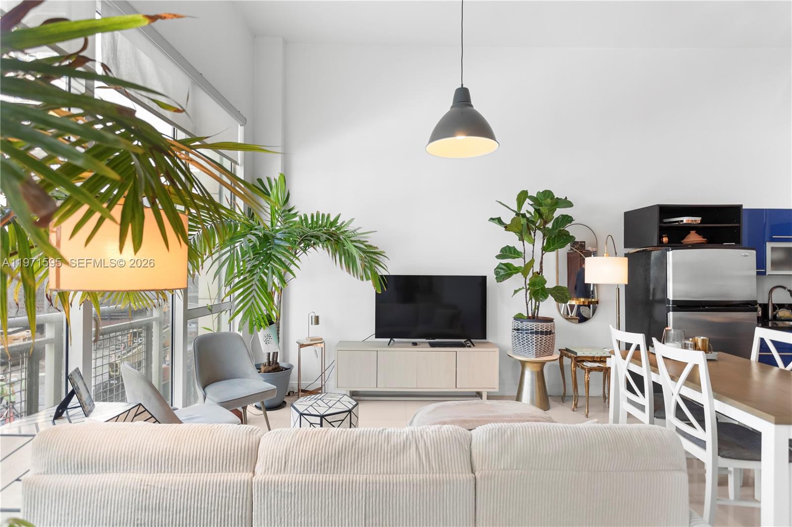 244 Biscayne Boulevard, Unit 252 Miami, FL 33132 - Photo 13 of 18 a living room with furniture and a potted plant
