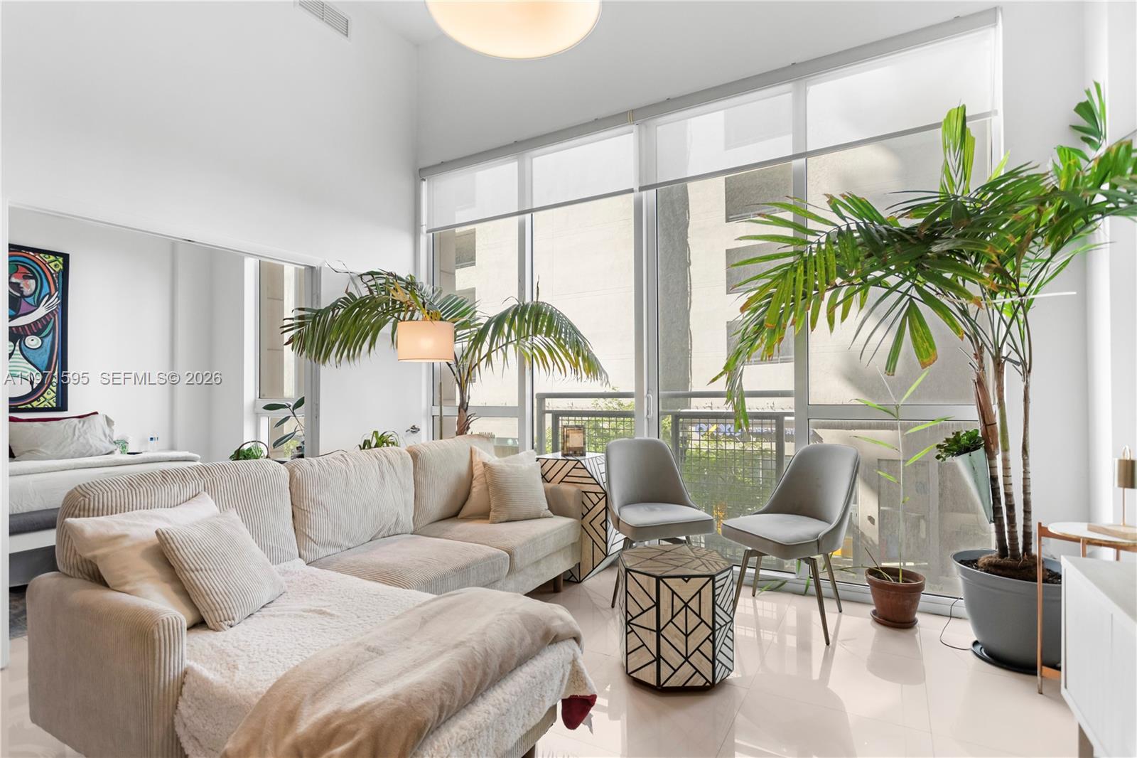 244 Biscayne Boulevard, Unit 252 Miami, FL 33132 - Photo 8 of 18 a living room with furniture and a potted plant