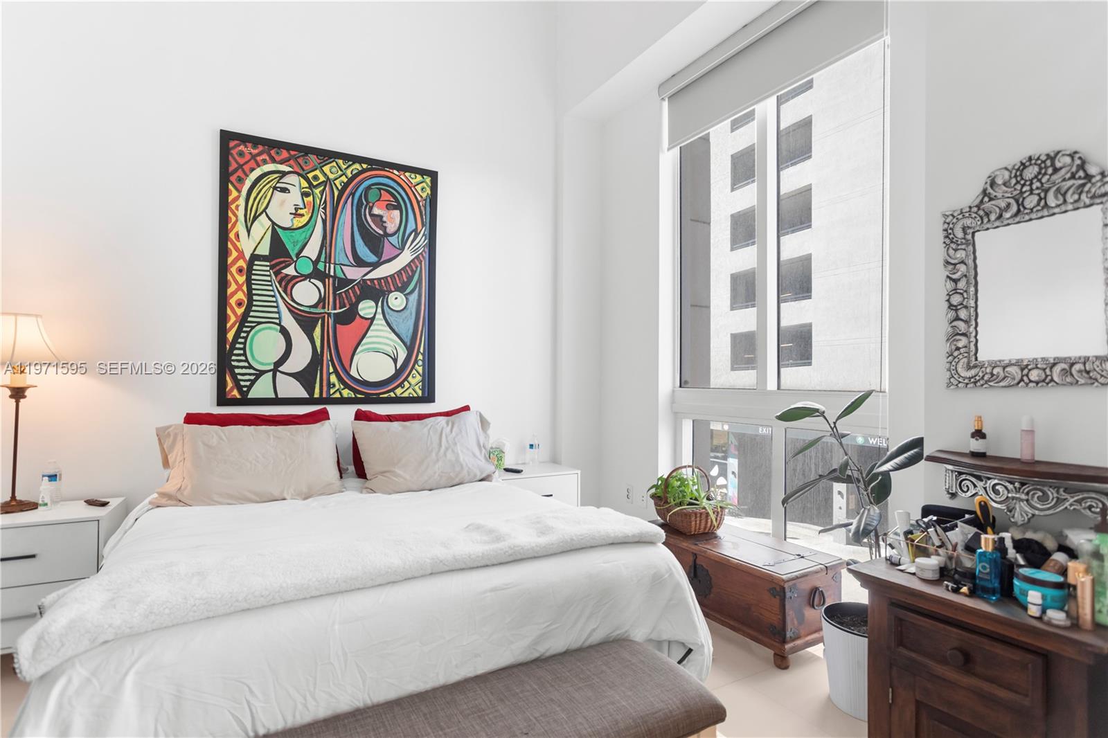 244 Biscayne Boulevard, Unit 252 Miami, FL 33132 - Photo 10 of 18 a bedroom with bed and painting on the wall