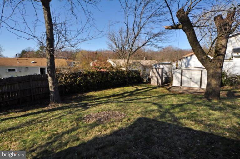 Large rear fenced yard with shed.