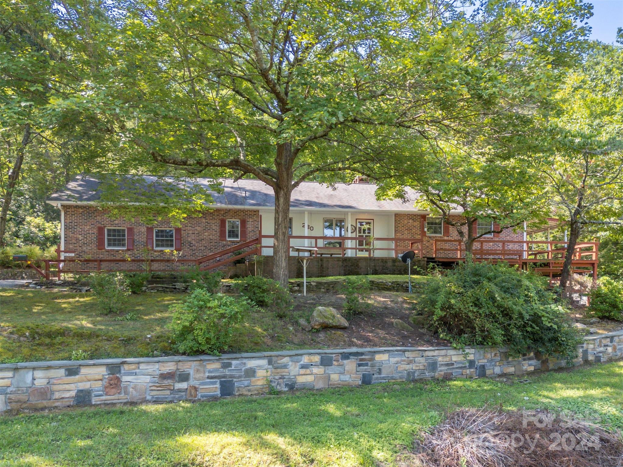 280 Dug Hill Road Landrum, SC 29356 - Photo 1 of 45 a front view of a house with a garden