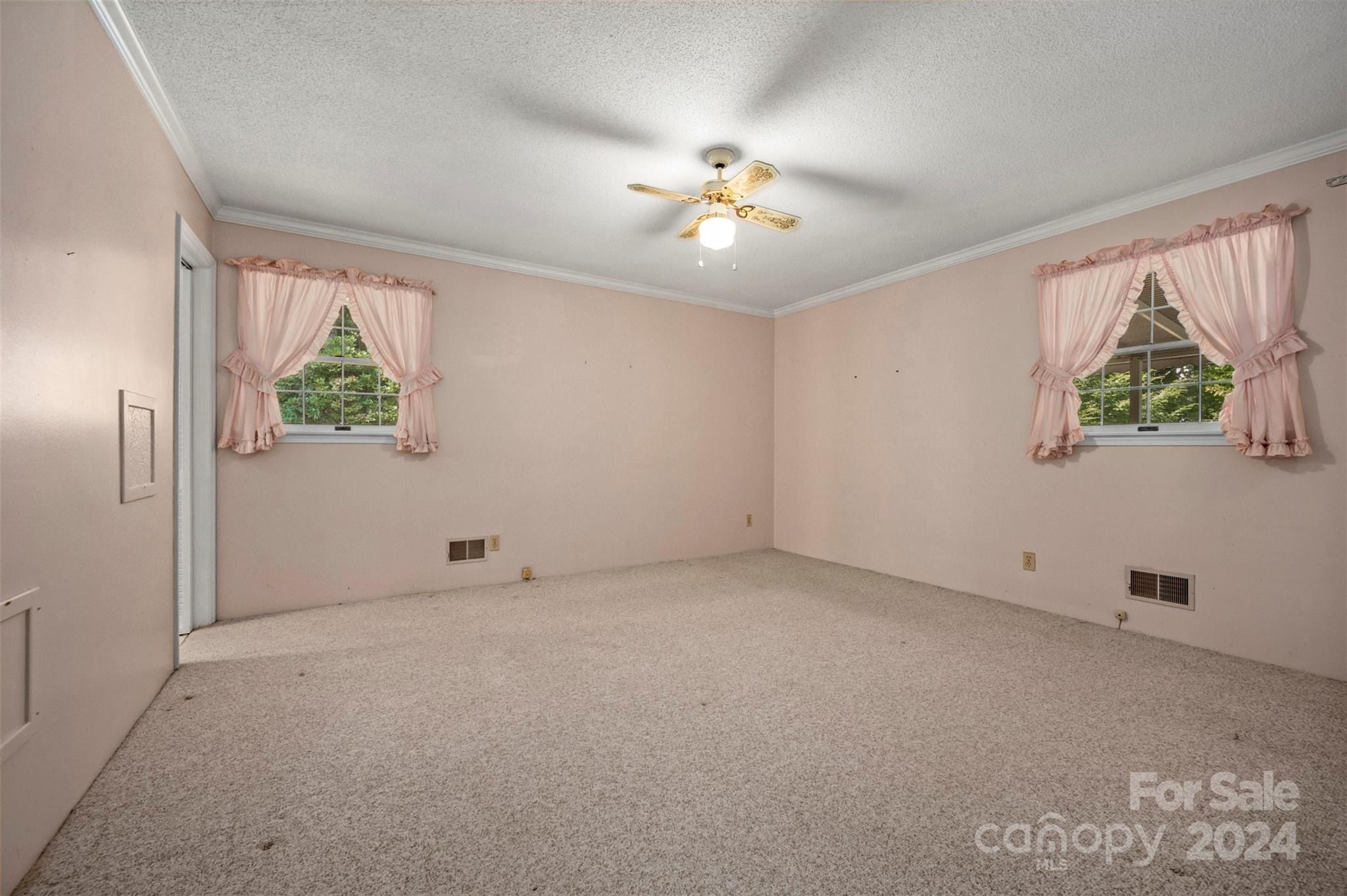 280 Dug Hill Road Landrum, SC 29356 - Photo 22 of 45 an empty room with windows and chandelier fan