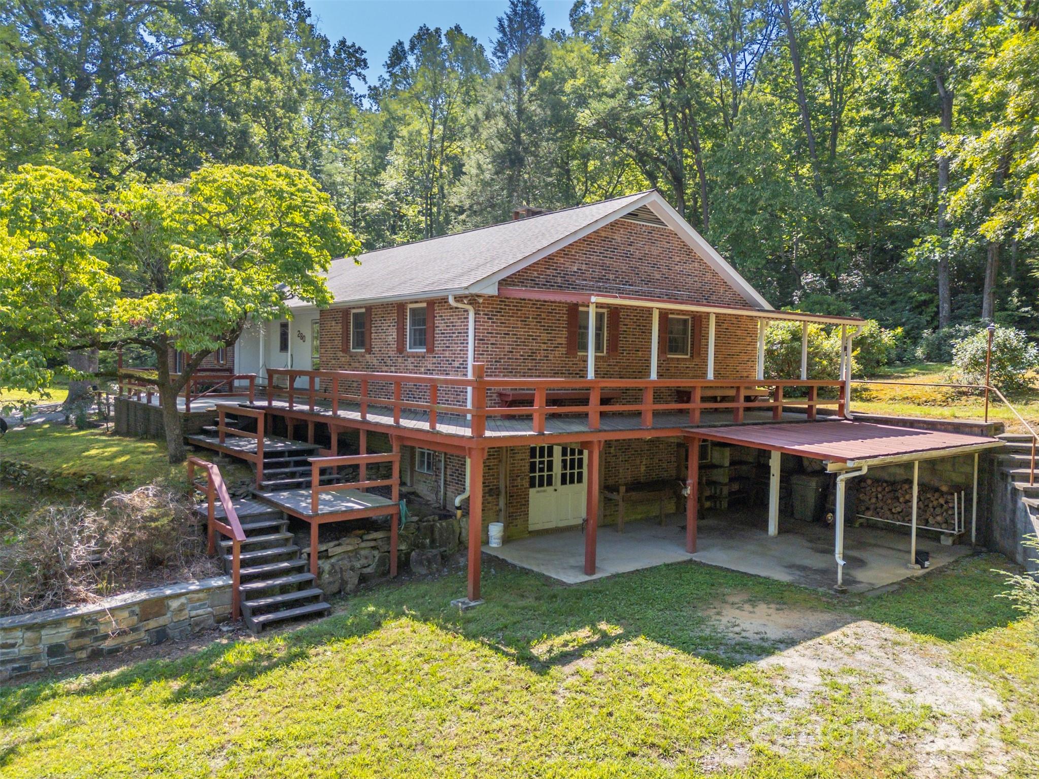 280 Dug Hill Road Landrum, SC 29356 - Photo 3 of 45 a view of a house with a yard patio and swimming pool