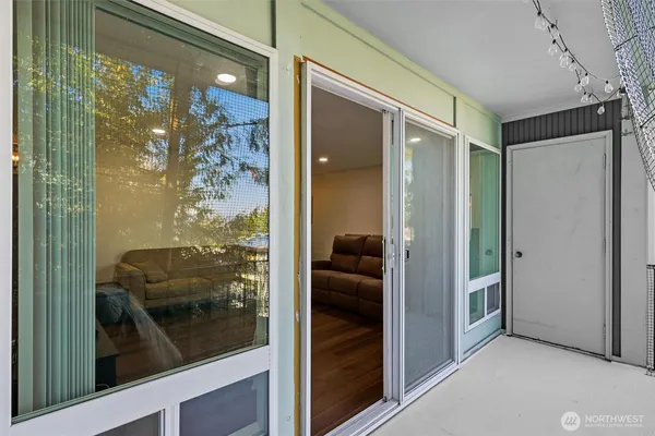 a bathroom with a glass shower door and a mirror