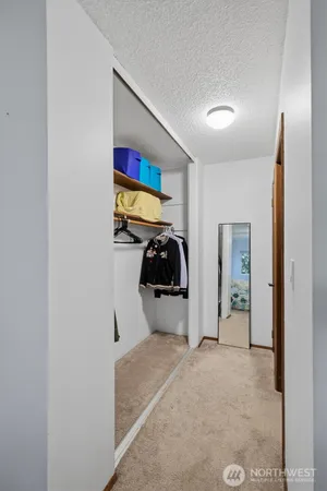 a bathroom with a granite countertop sink a toilet and a mirror