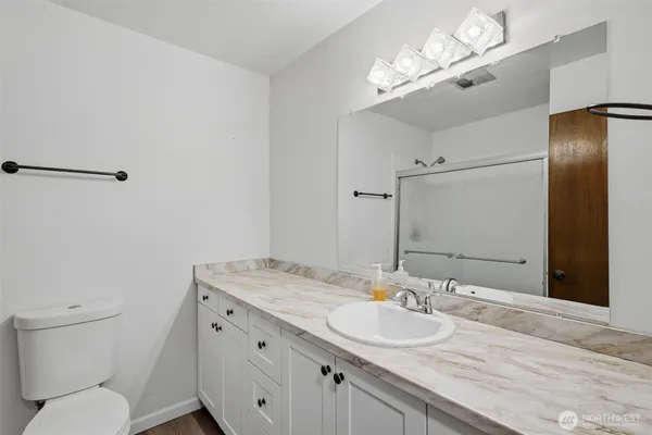 a white toilet sitting next to a bathroom sink