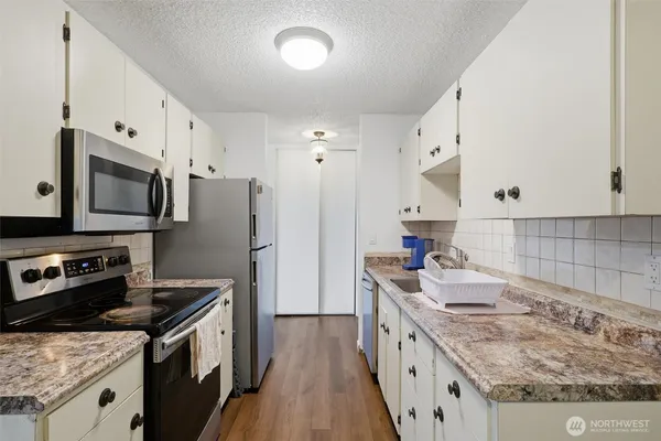 a kitchen with a sink stove and refrigerator