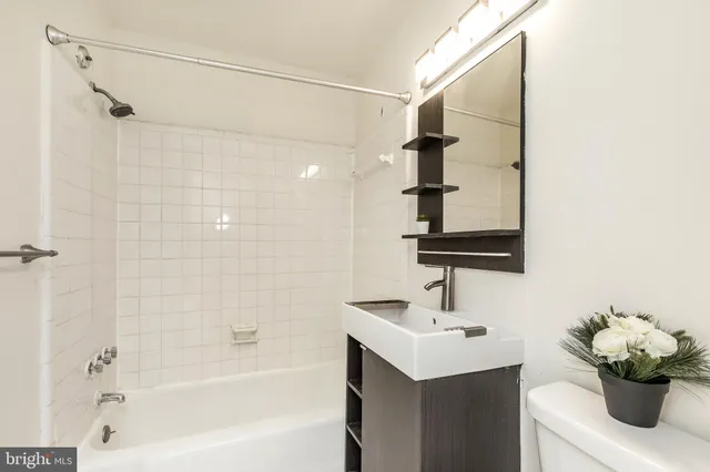 a bathroom with a sink a shower and a mirror