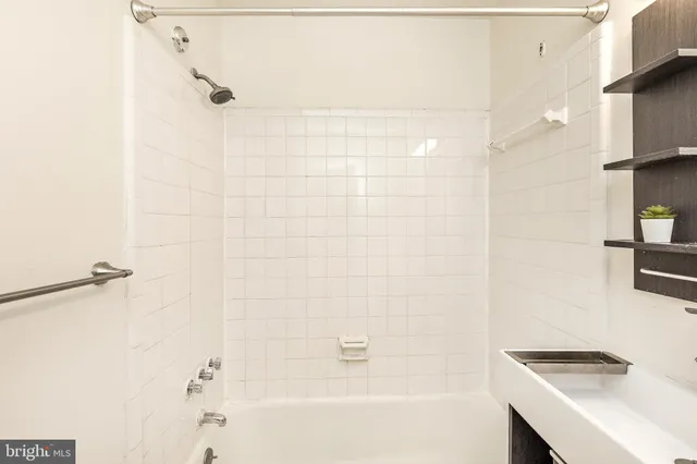 a bathroom with a bathtub and shower