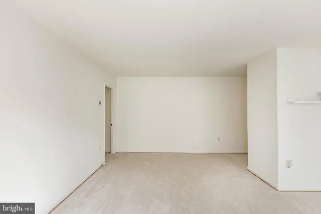 a view of a room with a window and a ceiling fan