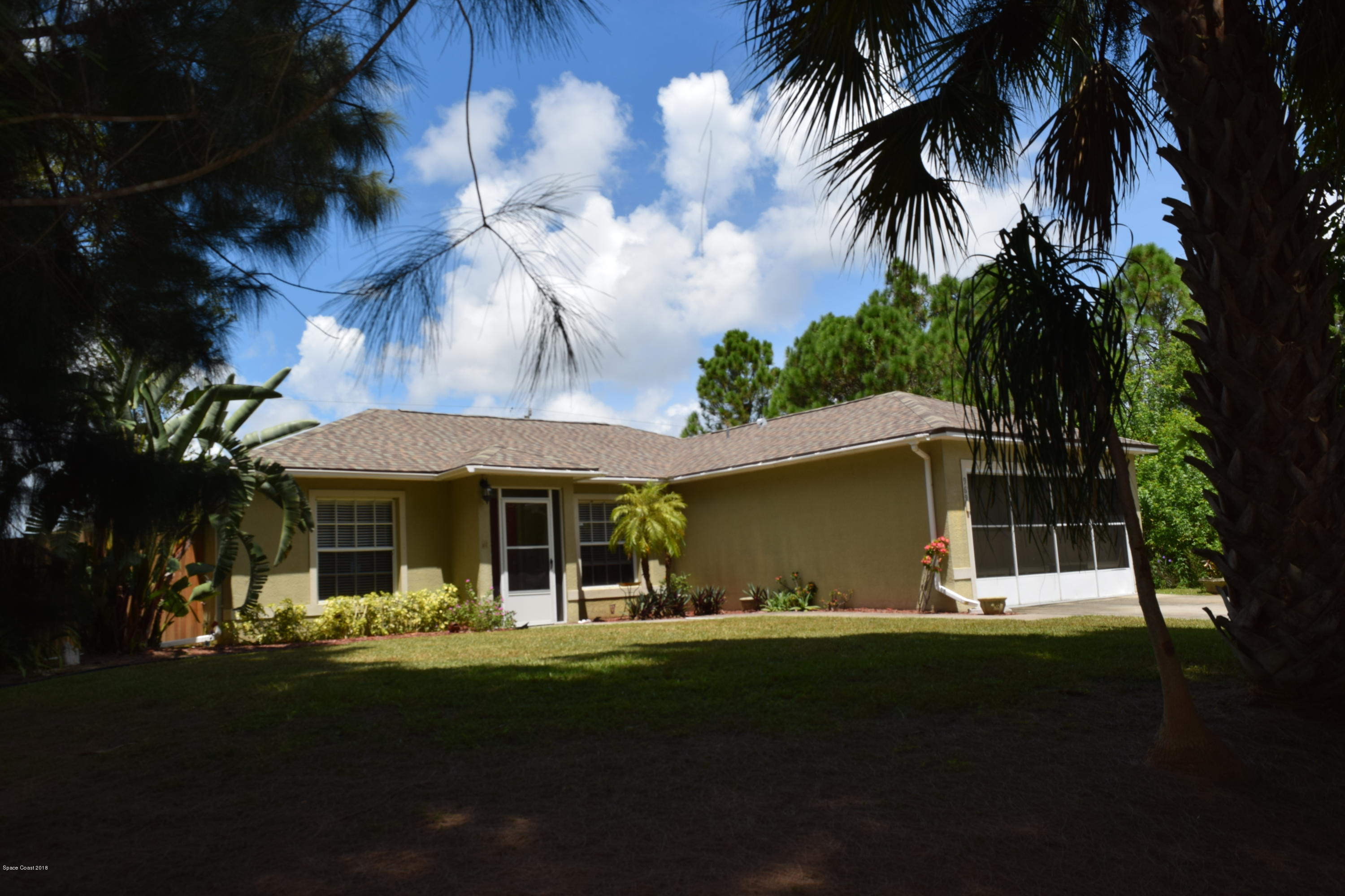 969 Ray Road Southeast Palm Bay, FL 32909 - Photo 1 of 22 a front view of a house with a garden