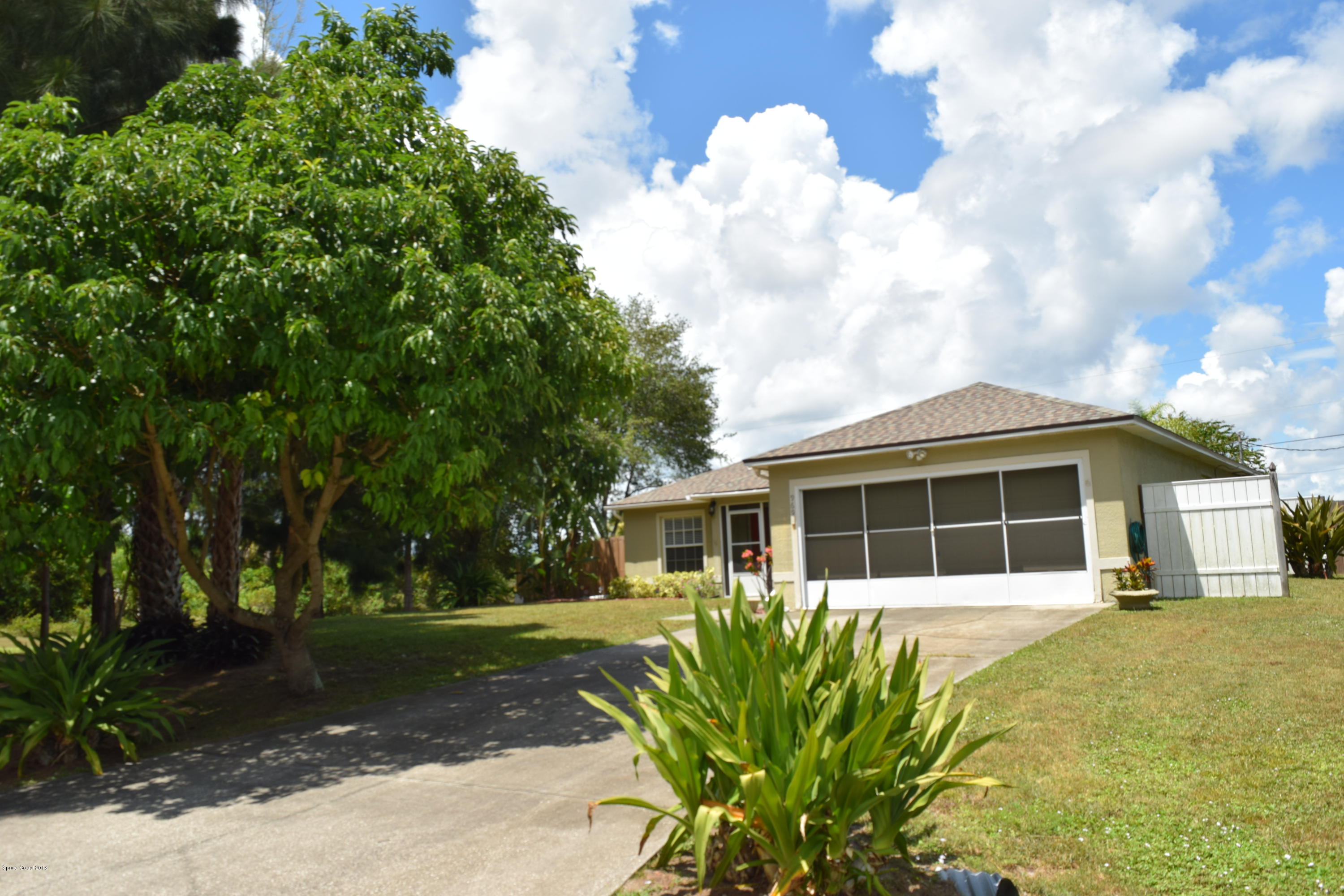 969 Ray Road Southeast Palm Bay, FL 32909 - Photo 2 of 22 a front view of a house with garden