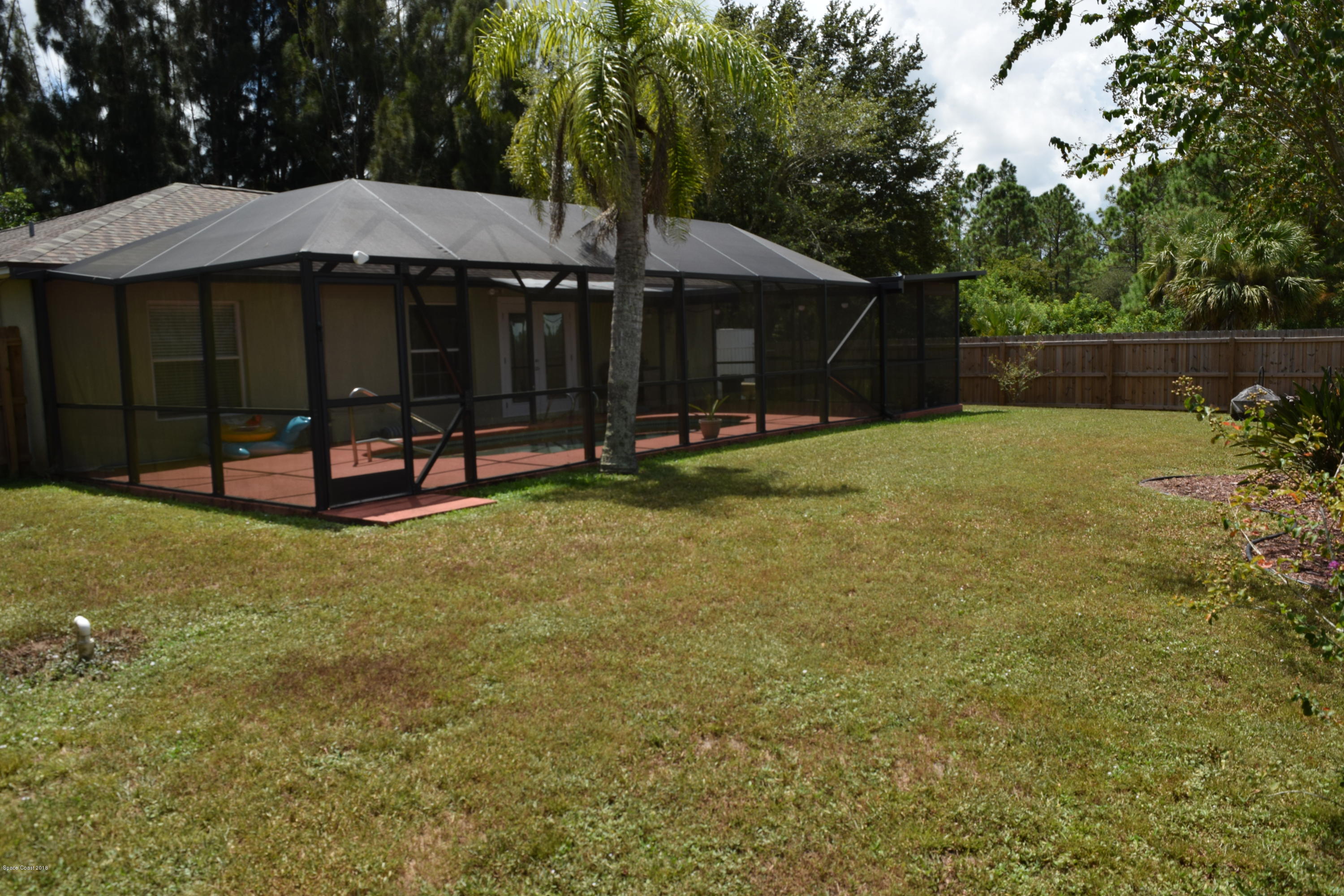 969 Ray Road Southeast Palm Bay, FL 32909 - Photo 15 of 22 a view of a house with backyard and sitting area