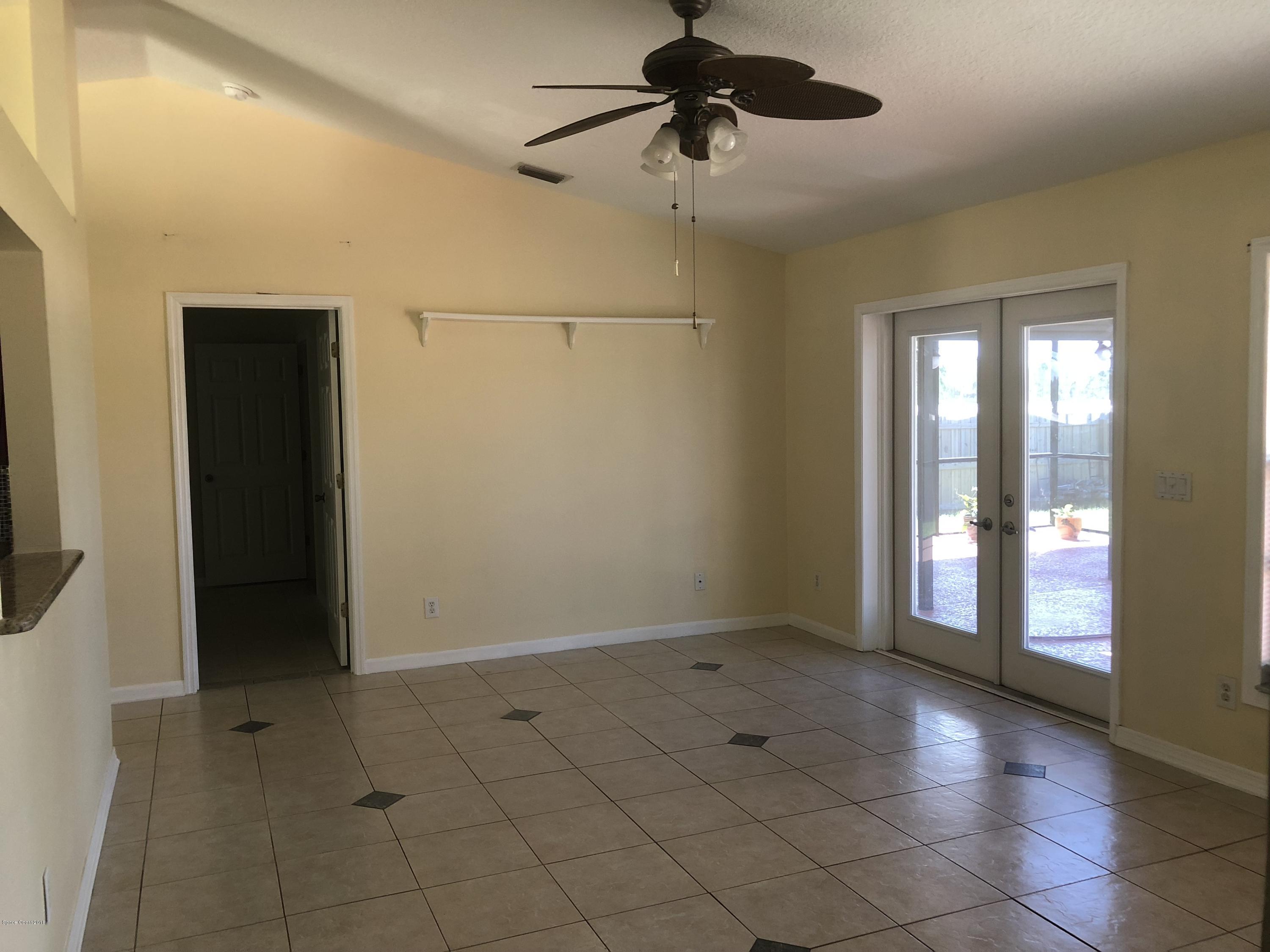 969 Ray Road Southeast Palm Bay, FL 32909 - Photo 4 of 22 a view of an empty room with a window