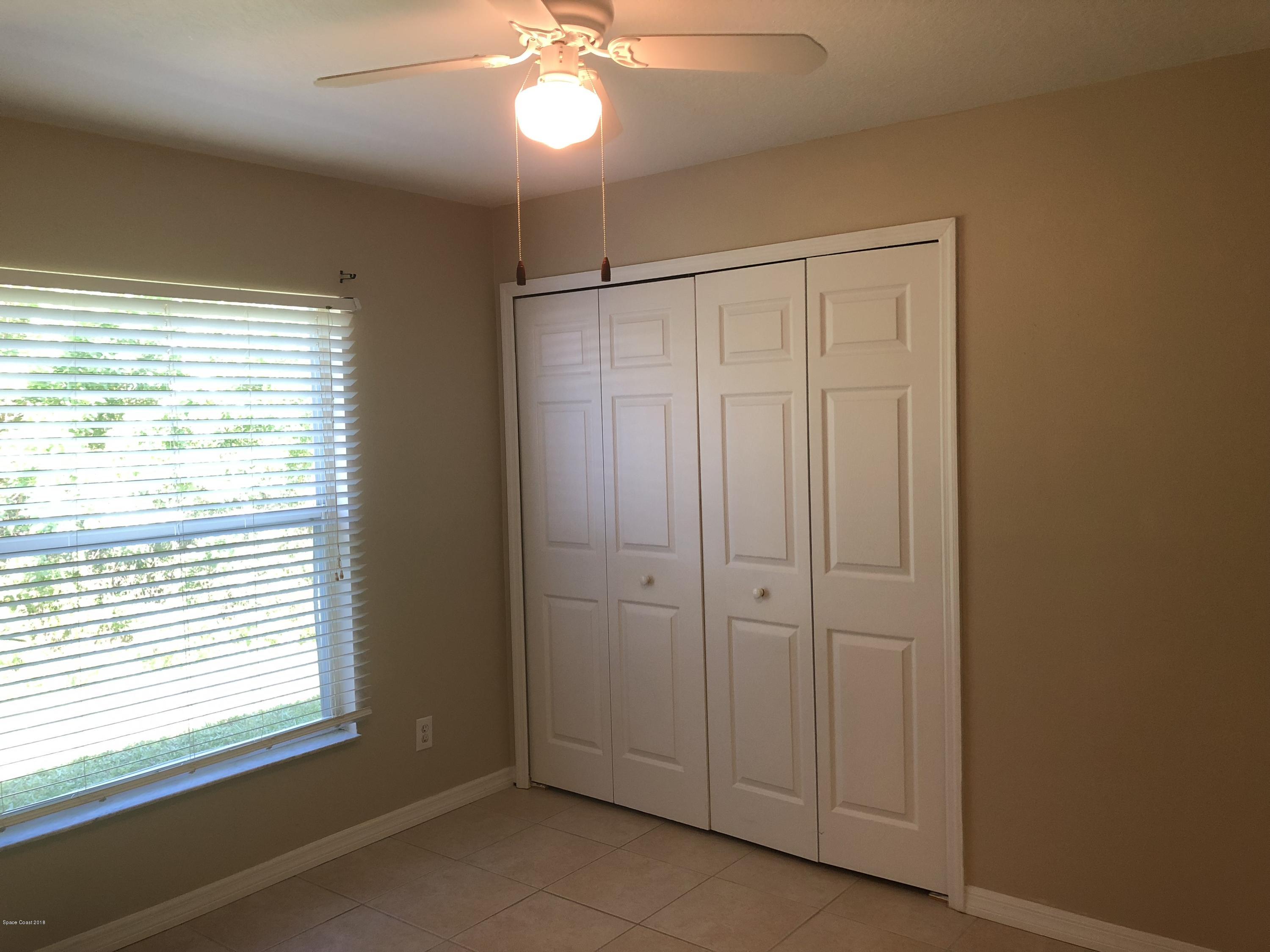 969 Ray Road Southeast Palm Bay, FL 32909 - Photo 7 of 22 a view of an empty room with a window