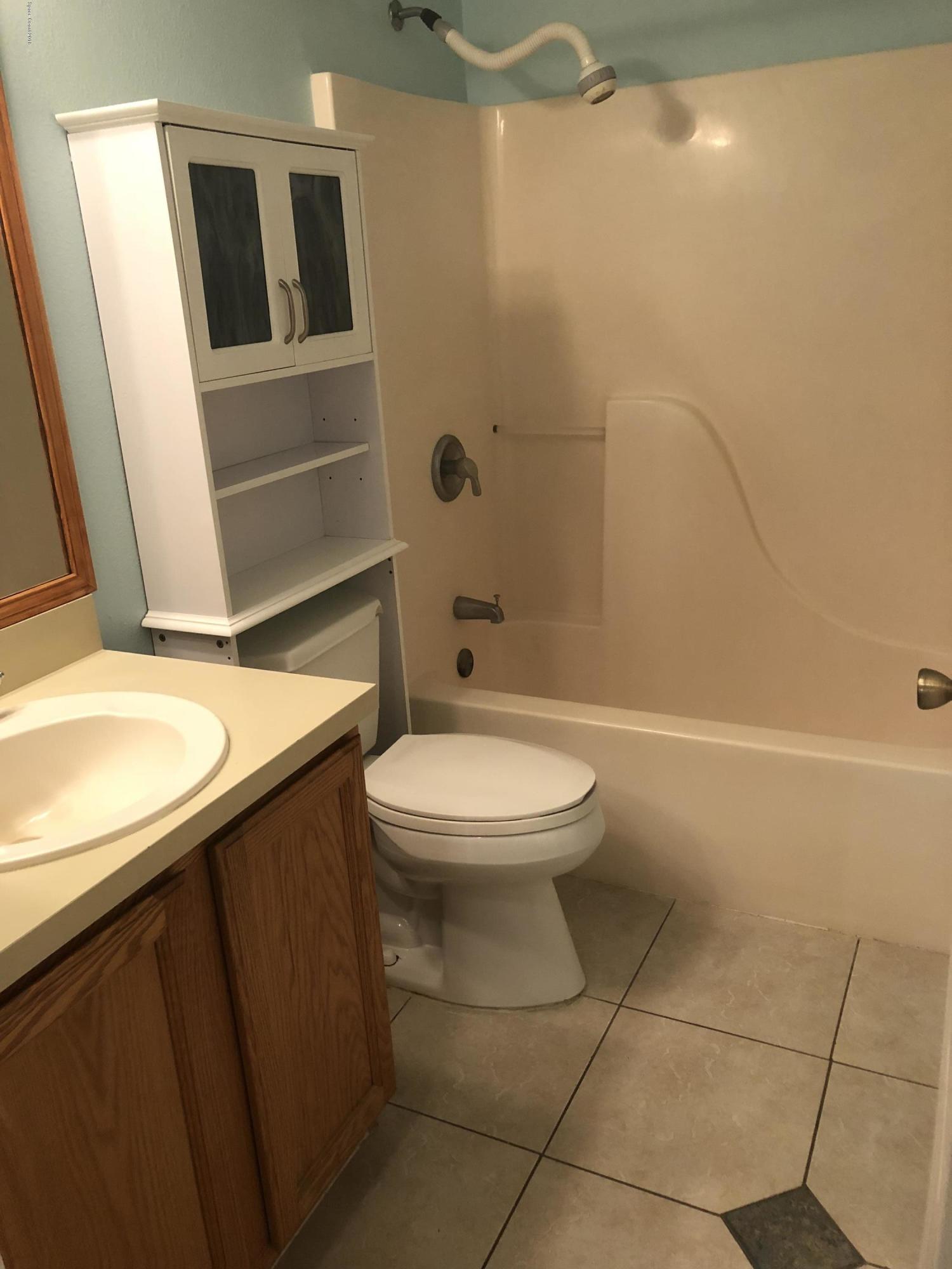 969 Ray Road Southeast Palm Bay, FL 32909 - Photo 9 of 22 a bathroom with a granite countertop toilet and a sink