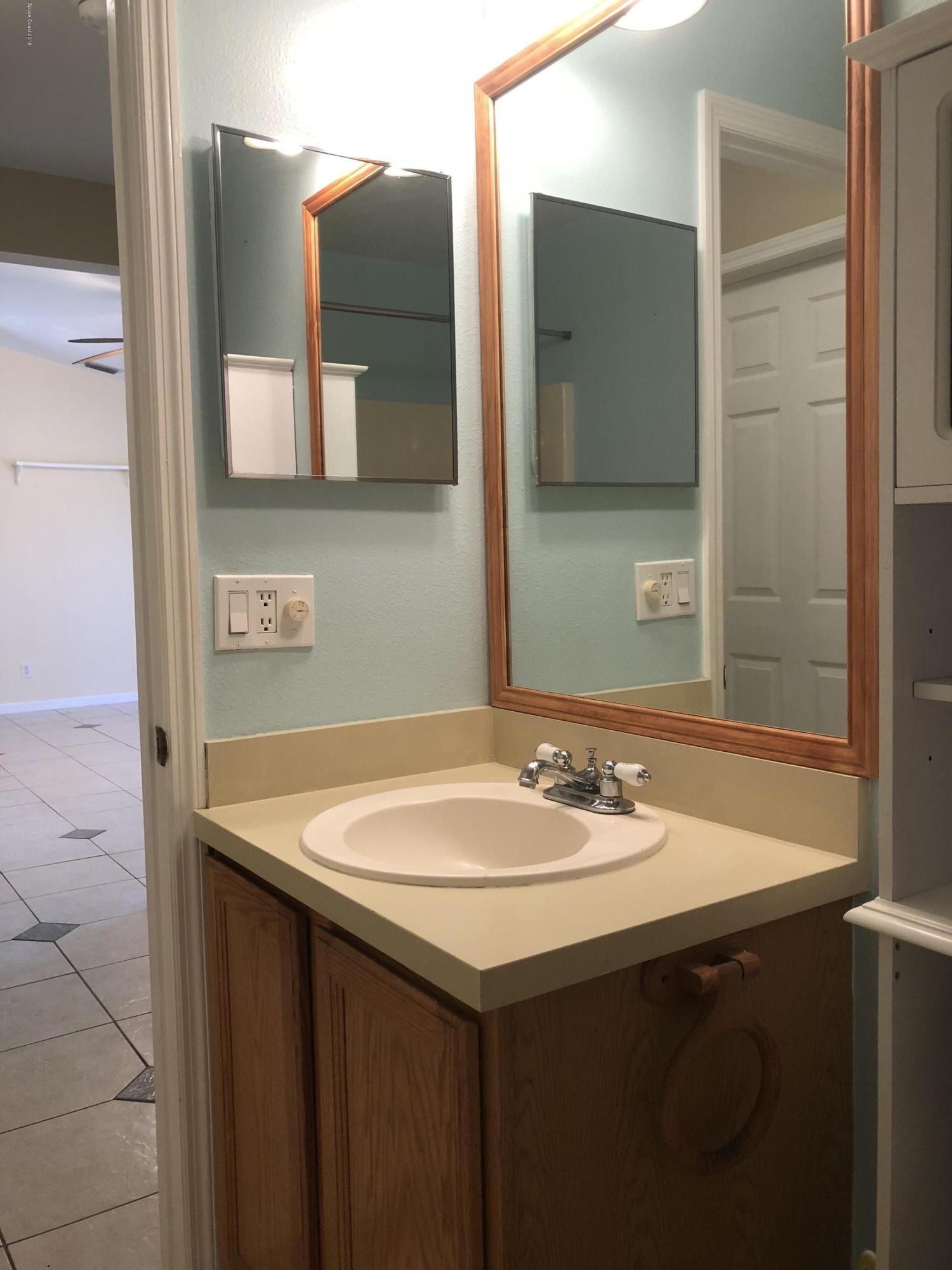 969 Ray Road Southeast Palm Bay, FL 32909 - Photo 10 of 22 a bathroom with a sink and a mirror