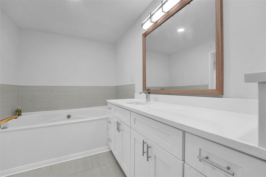 10525 Post Oak Bend Lane Wills Point, TX 75169 - Photo 13 of 40 Full bath featuring vanity, a garden tub, and light tile patterned floors