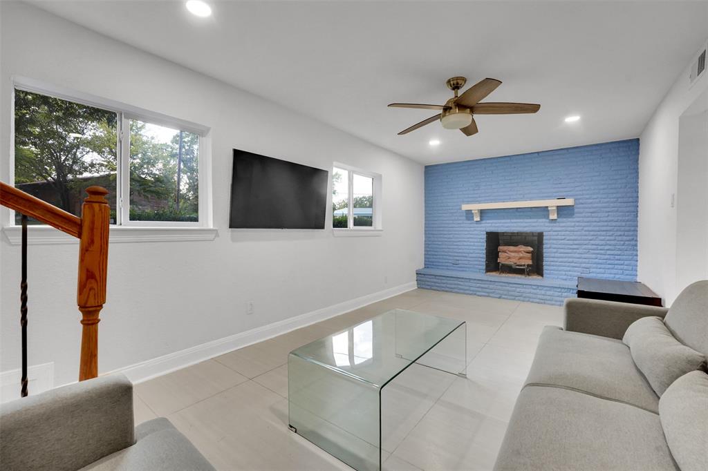 10525 Post Oak Bend Lane Wills Point, TX 75169 - Photo 18 of 40 Living room featuring light tile patterned floors, a ceiling fan, recessed lighting, a fireplace, and stairs
