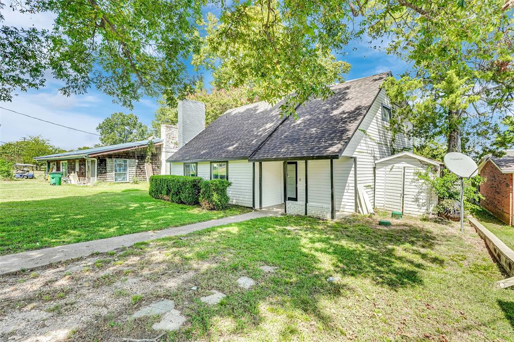 10525 Post Oak Bend Lane Wills Point, TX 75169 - Photo 2 of 40 View of front of house with a front lawn, a chimney, and a shingled roof