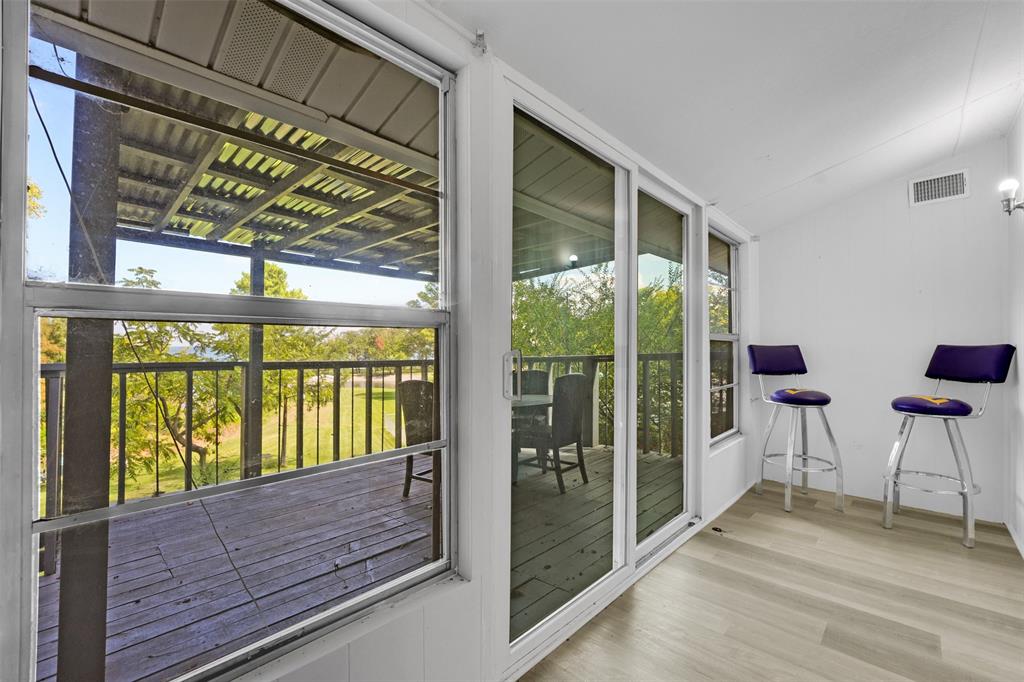 10525 Post Oak Bend Lane Wills Point, TX 75169 - Photo 28 of 40 Doorway with vaulted ceiling and wood finished floors